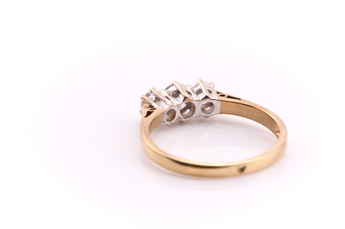 Lot 54 - A three stone half hoop diamond ring; the...