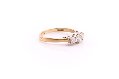 Lot 54 - A three stone half hoop diamond ring; the...