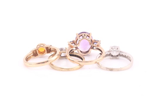Lot 613 - A three stone amethyst half hoop ring; the...