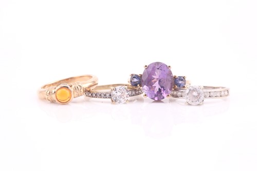 Lot 613 - A three stone amethyst half hoop ring; the...