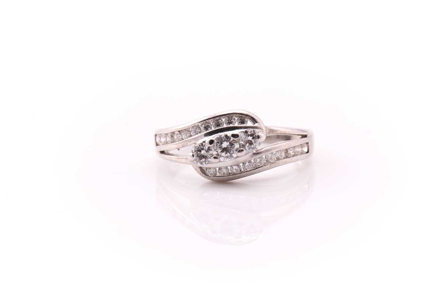 Lot 276 - A diamond three stone cross over ring, the...