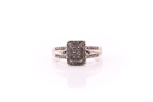 Lot 218 - A diamond cluster ring; the central...