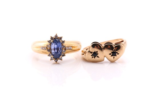 Lot 823 - A sapphire and diamond cluster ring, the oval...