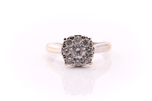 Lot 837 - A seven stone diamond cluster ring, the round...