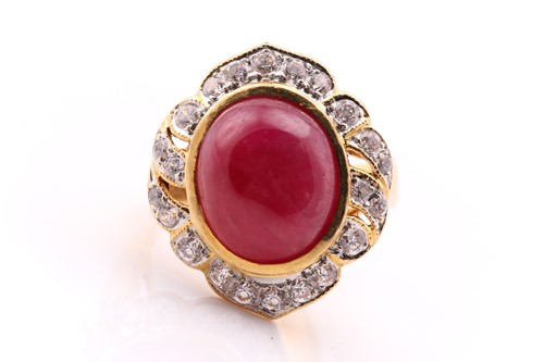 Lot 521 - A large ruby cluster ring; the milky oval...