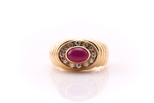 Lot 659 - A star ruby and diamond ring; the oval ruby in...