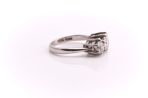 Lot 117 - A three stone half hoop diamond ring; the...