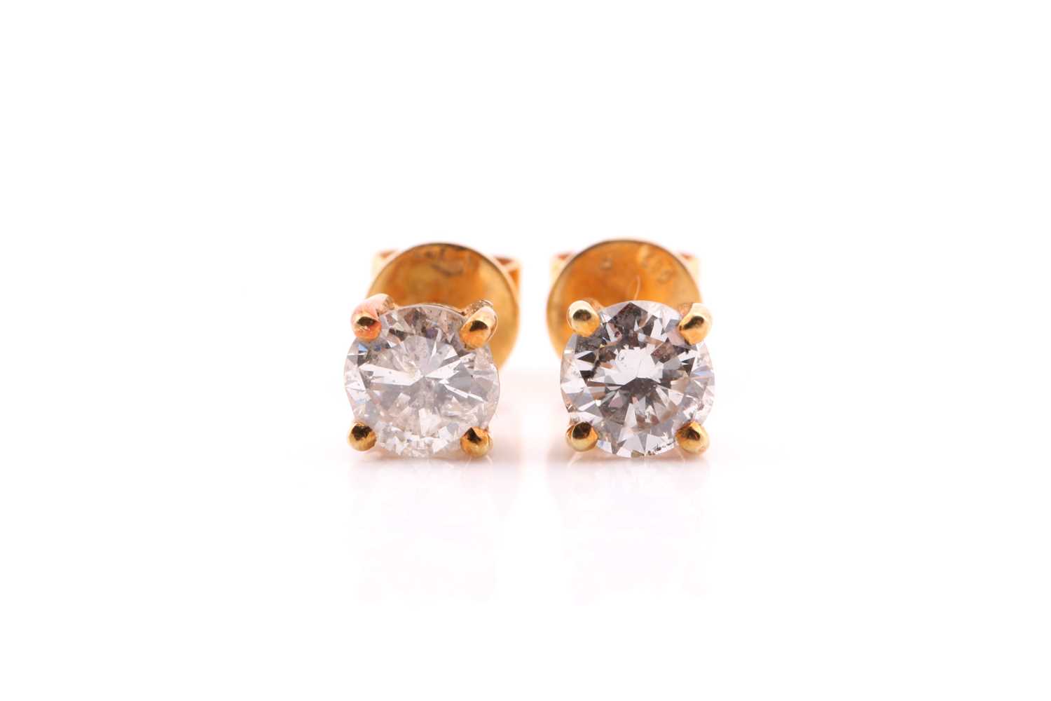 Lot 8 - A pair of diamond single stone earrings; the...