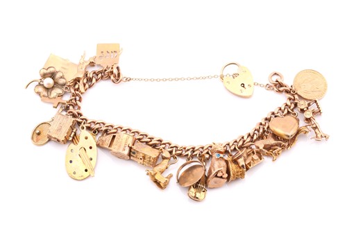 Lot 221 - A 9 carat yellow gold curb link charm bracelet...
