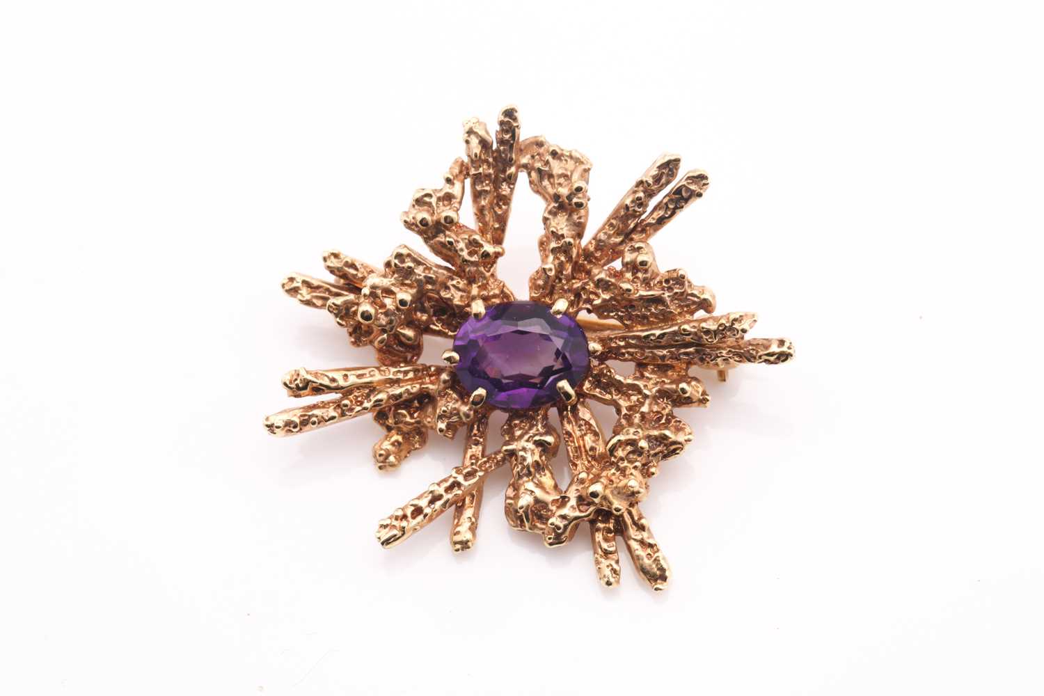 Lot 97 - An amethyst abstract brooch, 1970s, the...