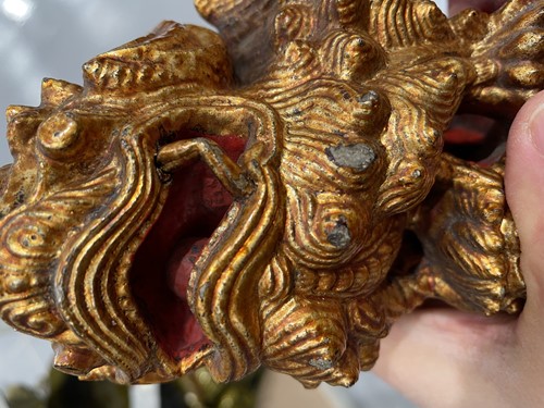 Lot 156 - A large carved and gilded wood temple lion,...