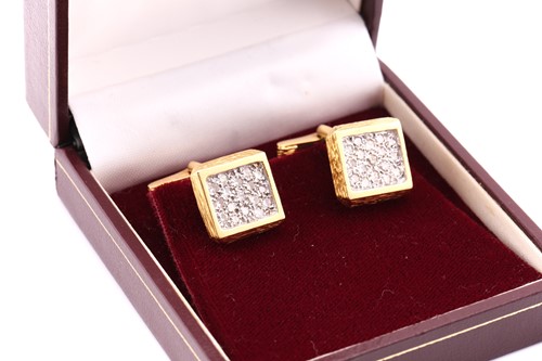 Lot 243 - A pair of 18 carat gold and diamond cufflinks;...