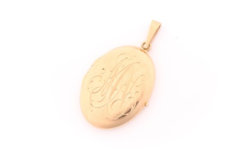 Lot 274 - A 14 carat gold oval locket; monogram engraved...