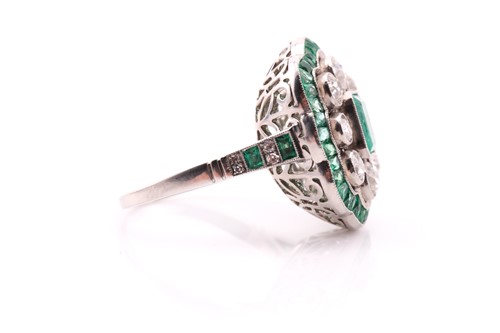 Lot 67 - An emerald and diamond cluster ring, the...