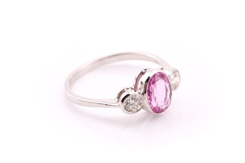 Lot 56 - A pink sapphire and diamond three stone ring...
