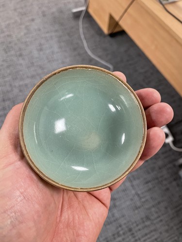 Lot 102 - A Chinese Longquan celadon bowl, the exterior...