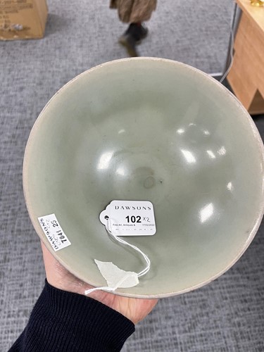 Lot 102 - A Chinese Longquan celadon bowl, the exterior...