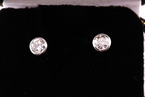 Lot 225 - A pair of diamond set stud earrings, in white...