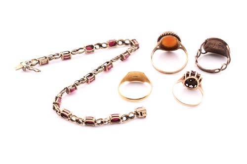 Lot 81 - A lot consisting of four rings and a bracelet,...
