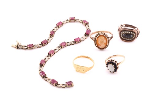 Lot 81 - A lot consisting of four rings and a bracelet,...