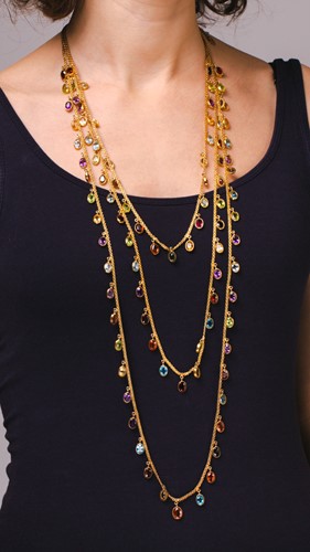 Lot 206 - A three strand multi-gem necklace, the long...