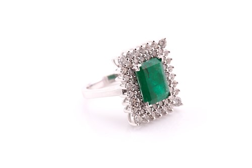 Lot 131 - An emerald and diamond cluster ring, the...