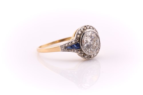 Lot 201 - A yellow and white metal halo ring, set with a...
