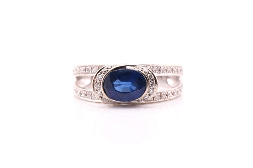 Lot 280 - A sapphire and diamond ring, the oval sapphire...