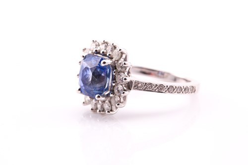 Lot 2 - A sapphire and diamond cluster ring, the...