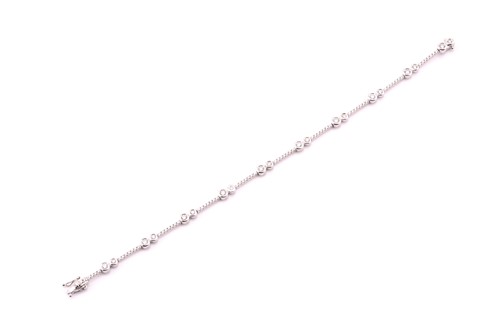 Lot 41 - A diamond line bracelet, composed of pairs of...