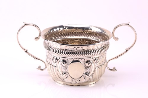 Lot 582 - A silver porringer with two scroll handles,...