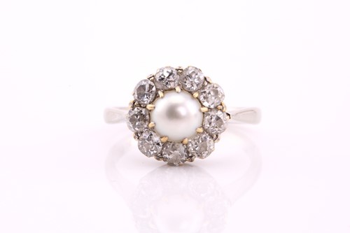 Lot 334 - A diamond and half pearl cluster ring, the...