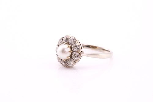 Lot 334 - A diamond and half pearl cluster ring, the...