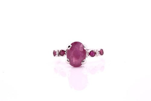 Lot 380 - A ruby and diamond dress ring, consisting of a...