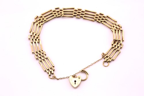 Lot 529 - A 9ct yellow gold gate bracelet and heart...