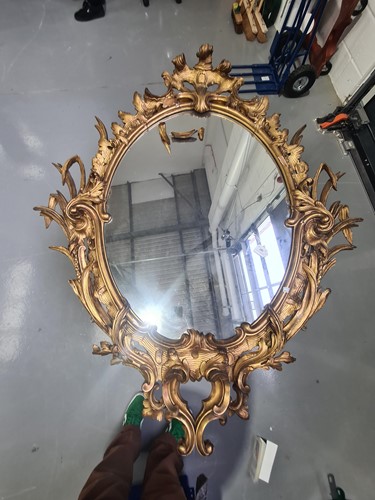Lot 287 - A large oval carved wood and gilt gesso rococo...