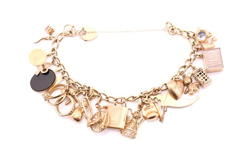Lot 193 - A 9ct gold charm bracelet, the curb link chain...