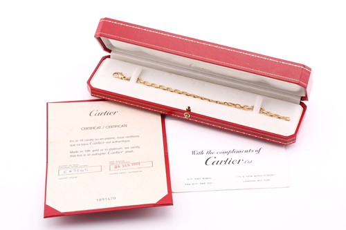 Lot 242 - A Cartier flat oval link bracelet measuring 20....