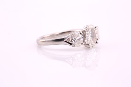 Lot 170 - An oval cut diamond three stone ring...