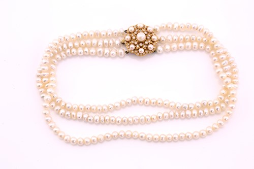 Lot 397 - A three row, freshwater pearl necklace, with a...