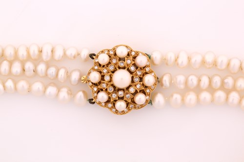 Lot 397 - A three row, freshwater pearl necklace, with a...