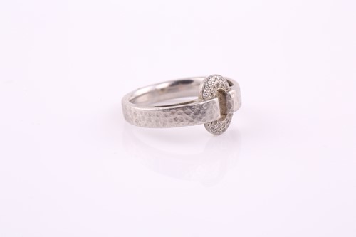 Lot 213 - A platinum ring and diamond ring; the looped...
