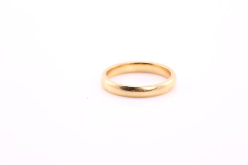 Lot 273 - An 18ct yellow gold court style wedding band,...