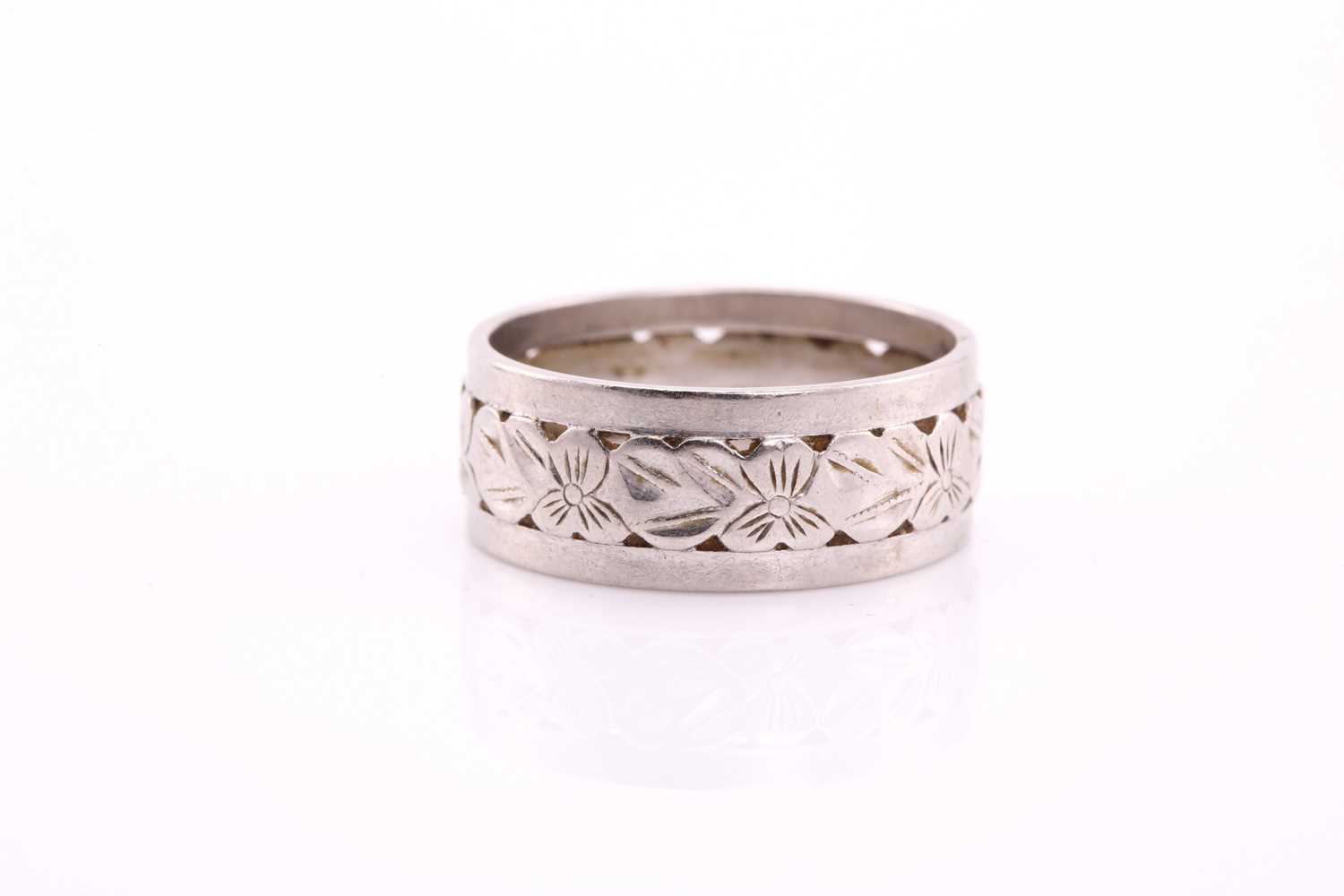 Lot 65 - A white precious metal wedding band, with...
