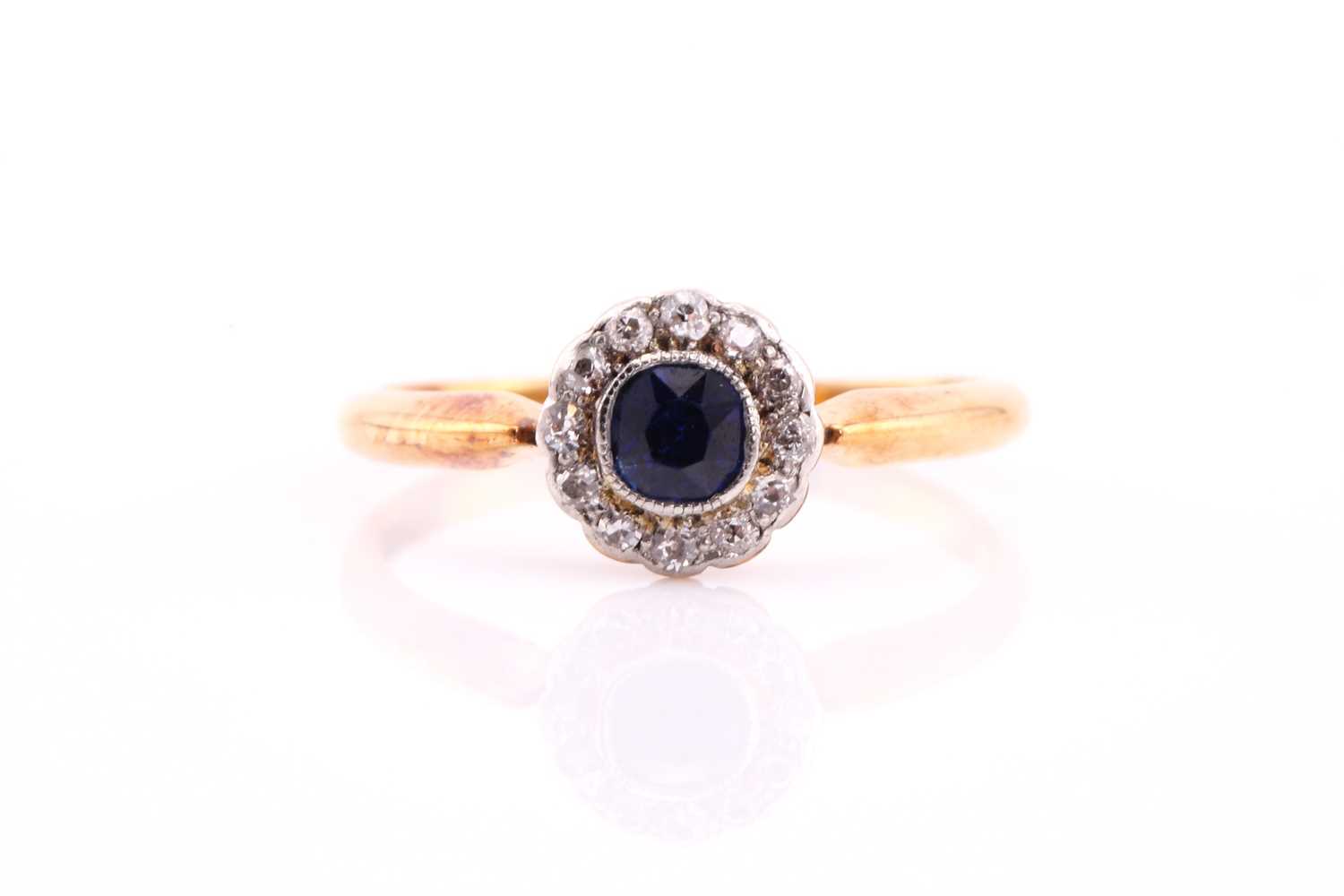 Lot 210 - A sapphire and diamond cluster ring, the round...