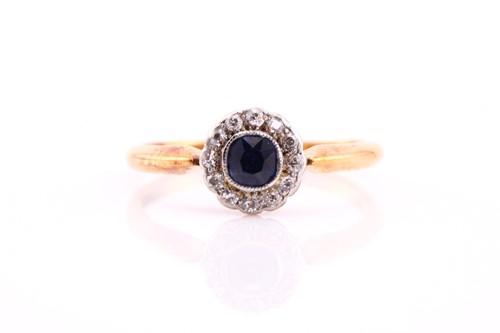 Lot 210 - A sapphire and diamond cluster ring, the round...