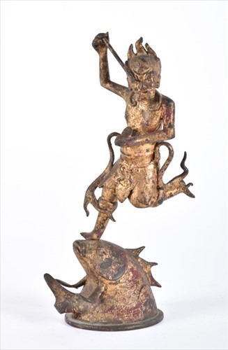 Lot 259 - An Oriental gilt metal sculpture of a fisher...