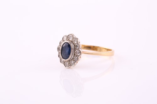 Lot 449 - A sapphire and diamond cluster ring, the oval...