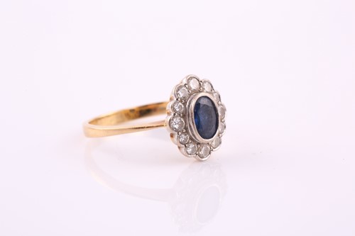 Lot 449 - A sapphire and diamond cluster ring, the oval...