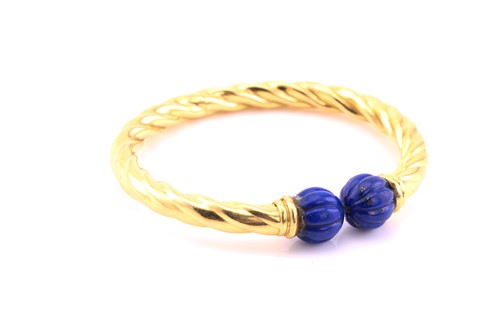 Lot 120 - A torc style hinged bracelet, the yellow...